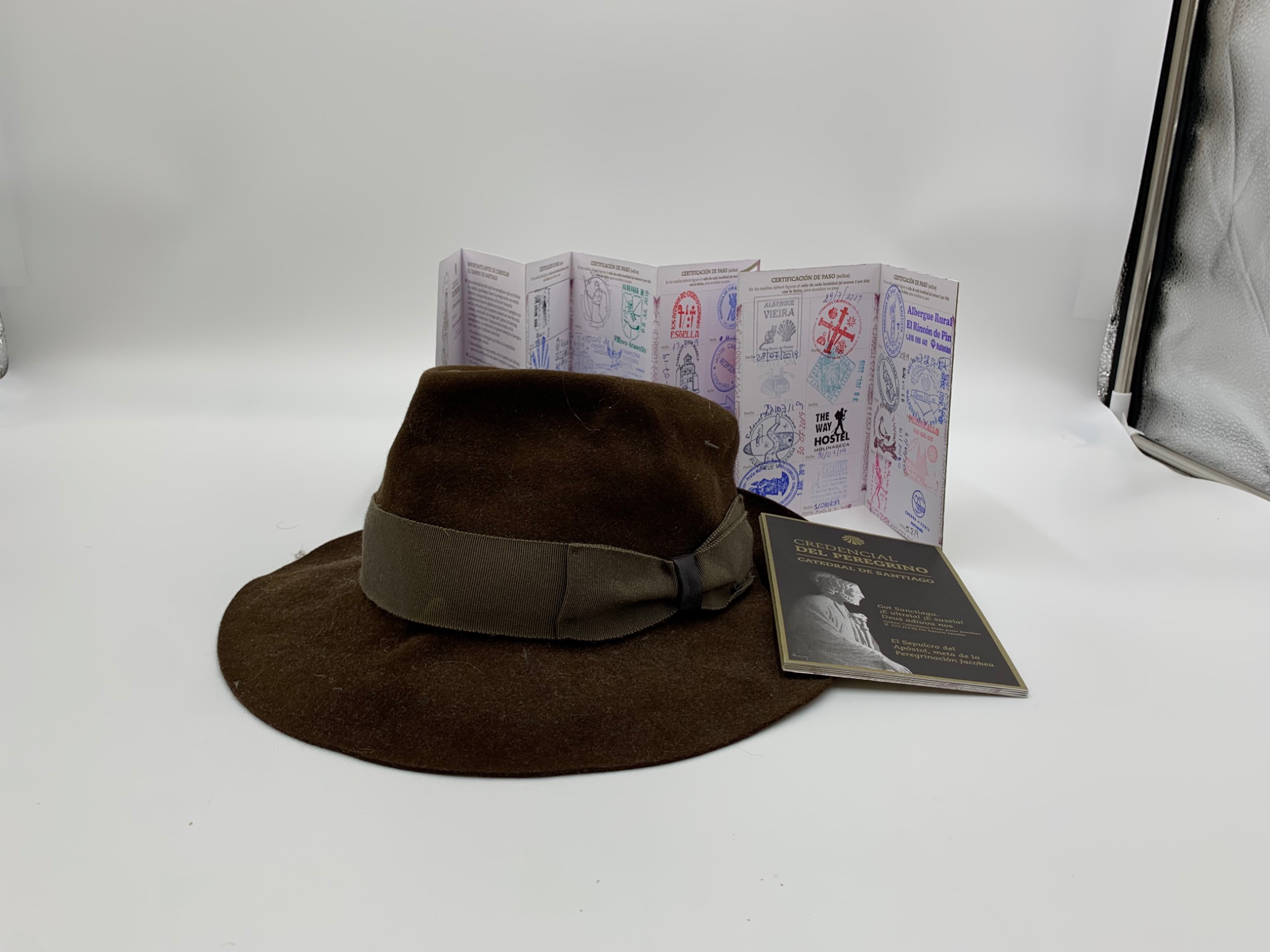 Walking hat with a stamped Camino de Santiago pilgrim credential