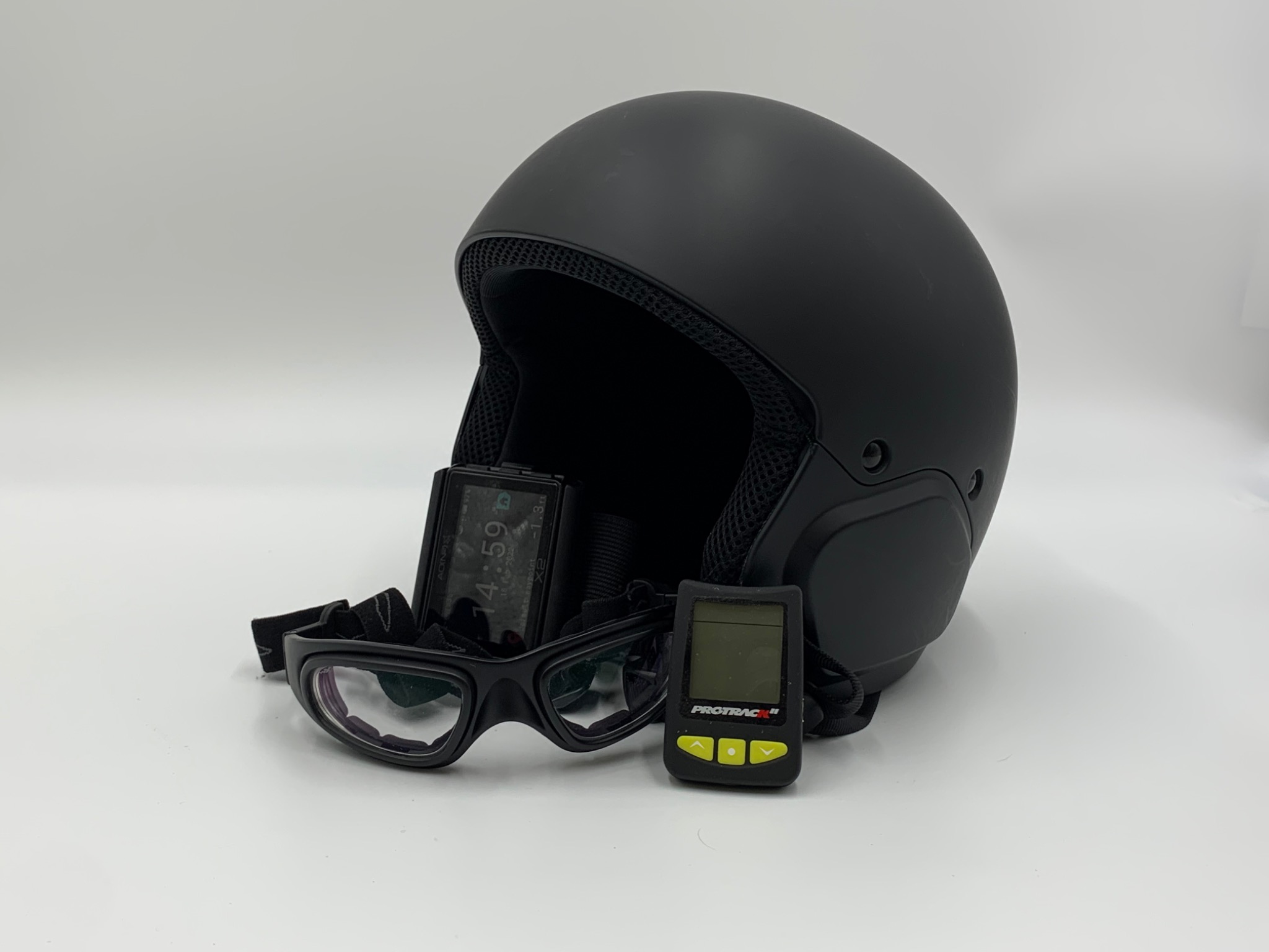 Black skydiving helmet, goggles, and altimeters
